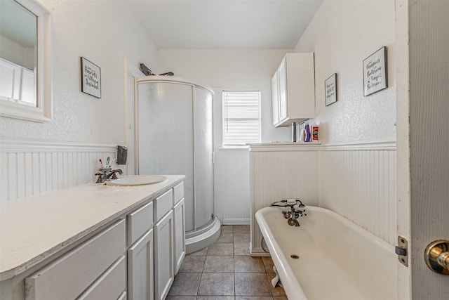 bathroom featuring tile patterned flooring, vanity, and shower with separate bathtub