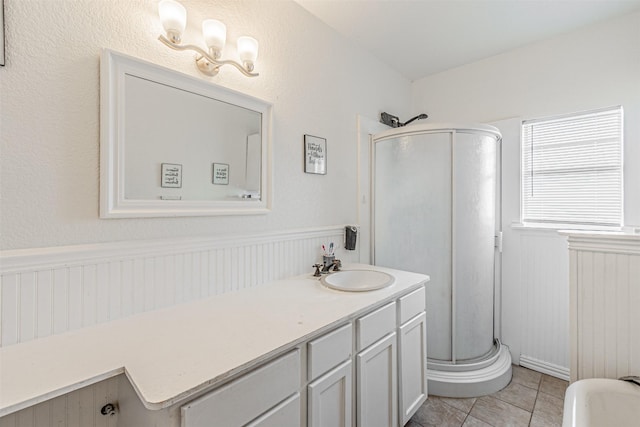 bathroom featuring tile patterned flooring, vanity, and walk in shower