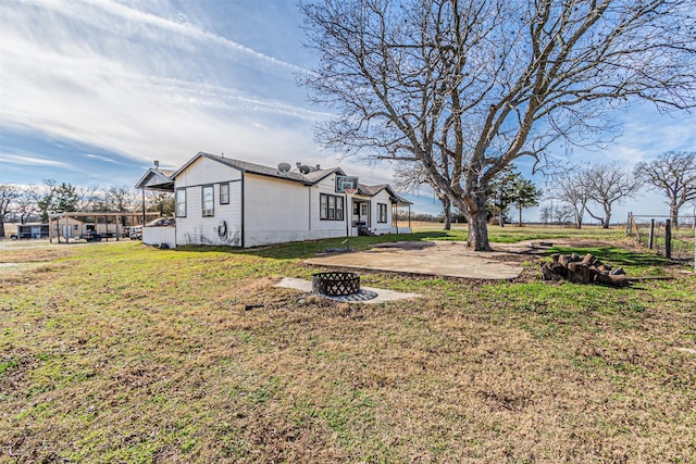 view of yard featuring a patio and an outdoor fire pit