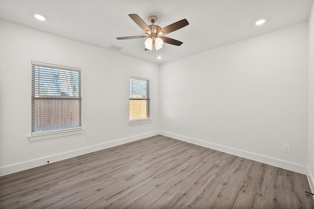 spare room featuring ceiling fan and light wood-type flooring