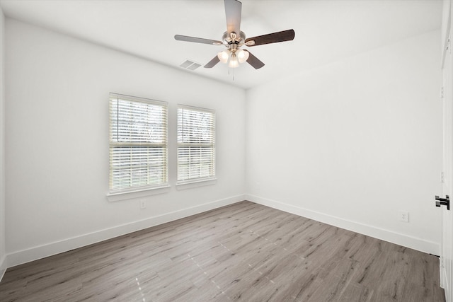 empty room featuring ceiling fan and light hardwood / wood-style floors