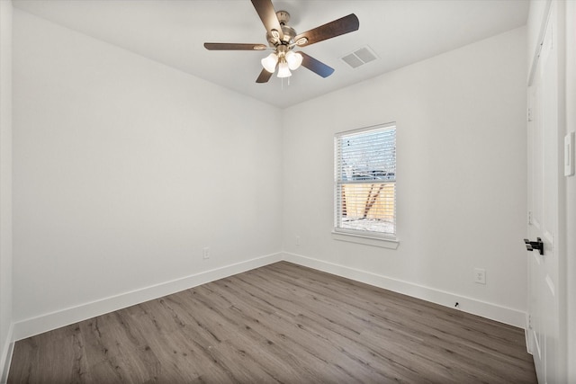 unfurnished room featuring ceiling fan and dark hardwood / wood-style flooring