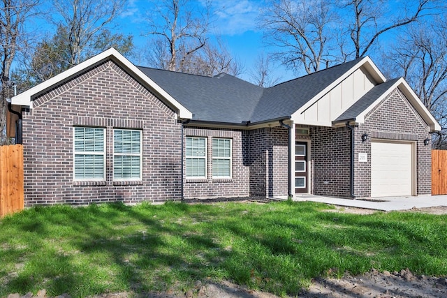 view of front of home with a garage and a front lawn