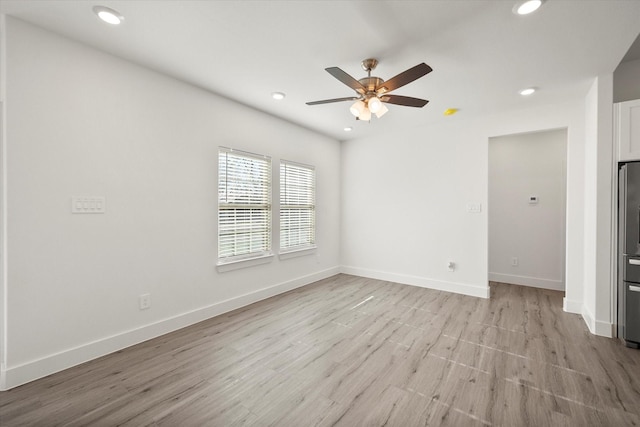 spare room with ceiling fan and light hardwood / wood-style floors