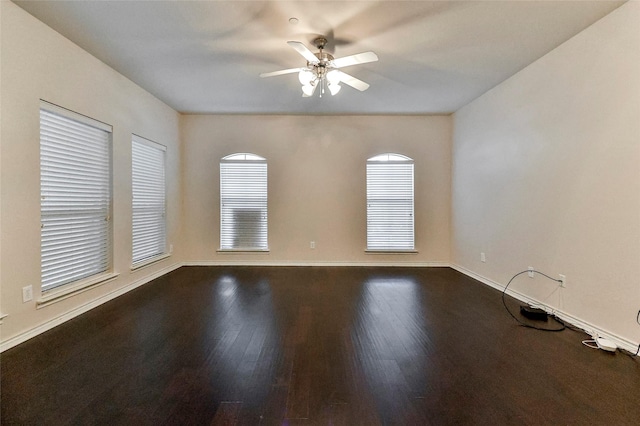 unfurnished living room featuring a fireplace, dark wood-type flooring, and ceiling fan