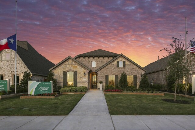 french provincial home featuring a yard