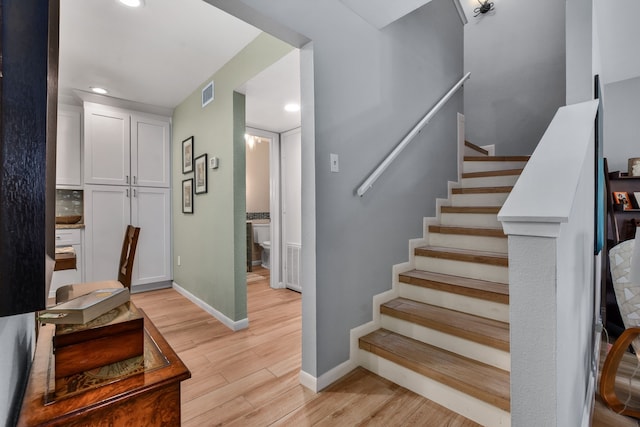 stairs with hardwood / wood-style floors