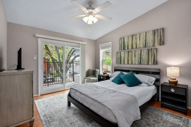 bedroom featuring hardwood / wood-style floors, ceiling fan, access to exterior, and lofted ceiling