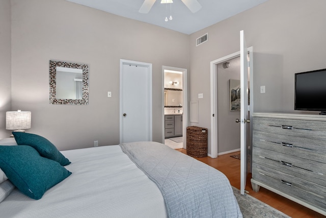 bedroom with connected bathroom, light hardwood / wood-style floors, and ceiling fan