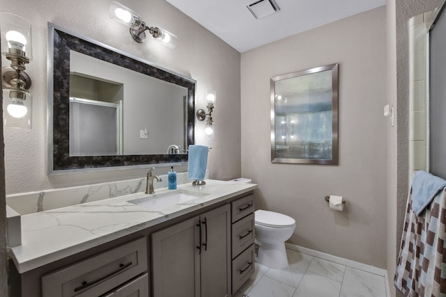 bathroom featuring vanity, toilet, and a shower