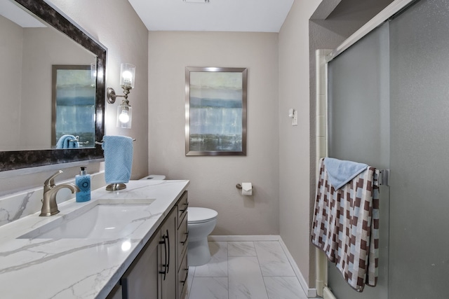 bathroom featuring vanity, toilet, and walk in shower