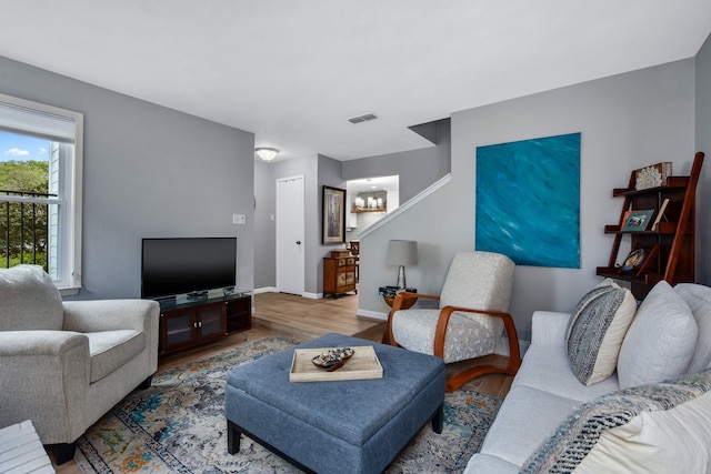 living room featuring hardwood / wood-style floors and a chandelier