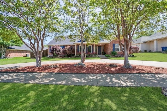 ranch-style house featuring a porch and a front yard