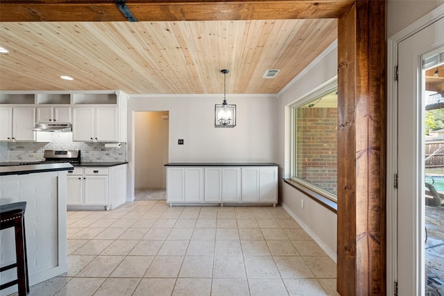 kitchen with tasteful backsplash, wood ceiling, crown molding, decorative light fixtures, and white cabinetry