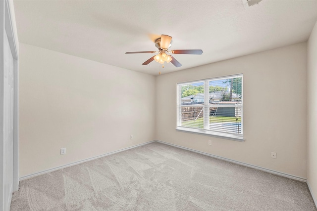 empty room featuring light carpet and ceiling fan