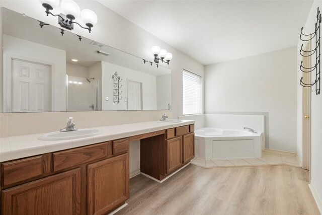 bathroom featuring vanity, separate shower and tub, and wood-type flooring