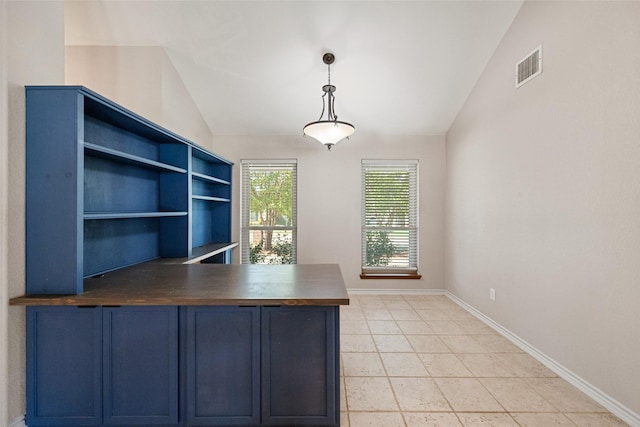 unfurnished office with tile patterned floors and vaulted ceiling