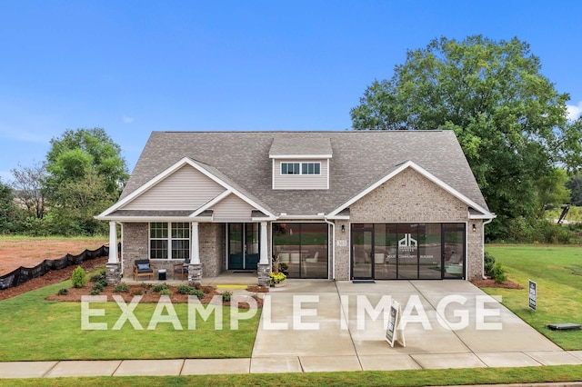 craftsman house with covered porch and a front lawn