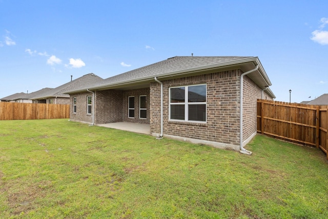209 Briarwood Dr, Nevada, TX 75173 - back of house with a patio, brick siding, a fenced backyard, and a shingled roof