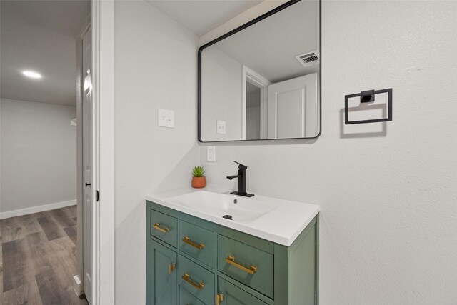 bathroom featuring vanity and hardwood / wood-style flooring