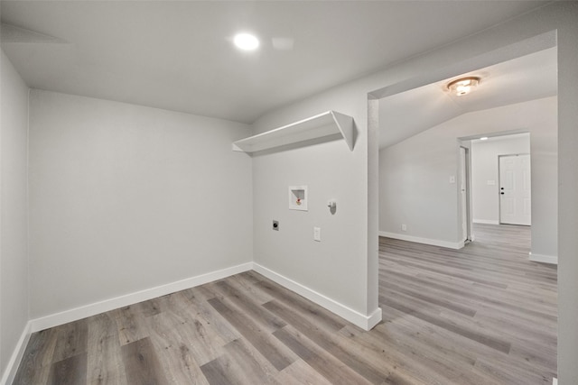 clothes washing area with hookup for an electric dryer, light wood-type flooring, and washer hookup