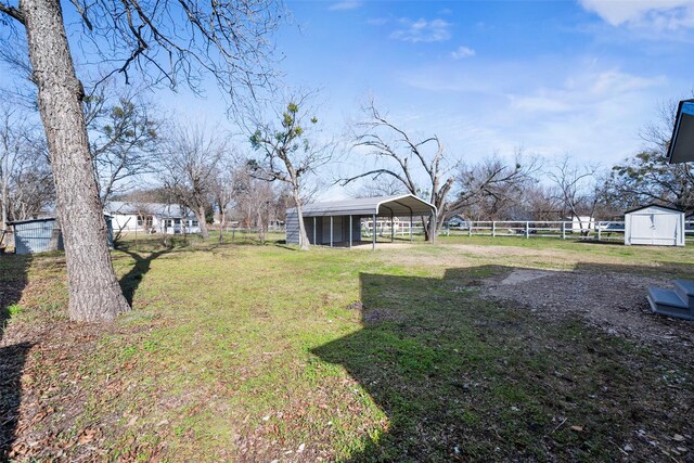 view of yard featuring a shed and a carport