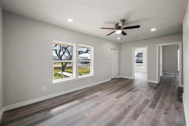 unfurnished room with ceiling fan and dark wood-type flooring