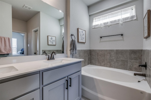 bathroom with a bathing tub and vanity