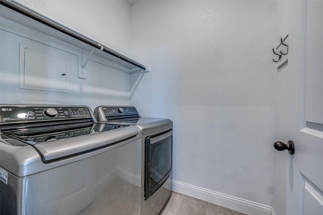 washroom featuring light tile patterned floors and separate washer and dryer