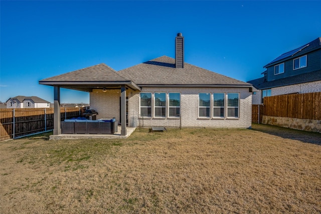 rear view of property featuring outdoor lounge area, ceiling fan, a patio area, and a lawn