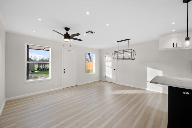 unfurnished living room featuring ceiling fan and light wood-type flooring