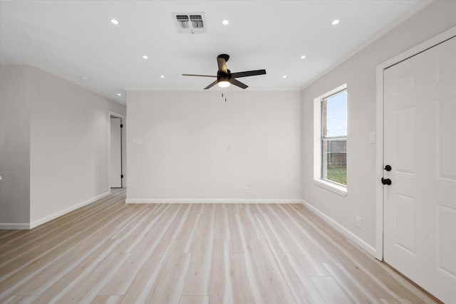 spare room with ceiling fan and light wood-type flooring