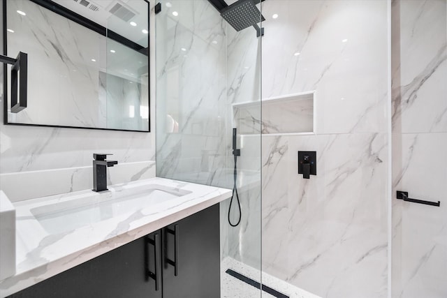 bathroom featuring vanity and a shower with door