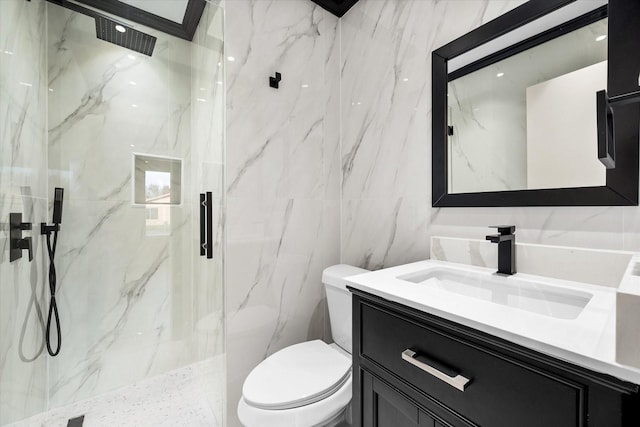 bathroom with an enclosed shower, vanity, tile walls, and toilet