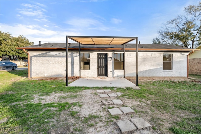 back of property featuring a patio and a lawn