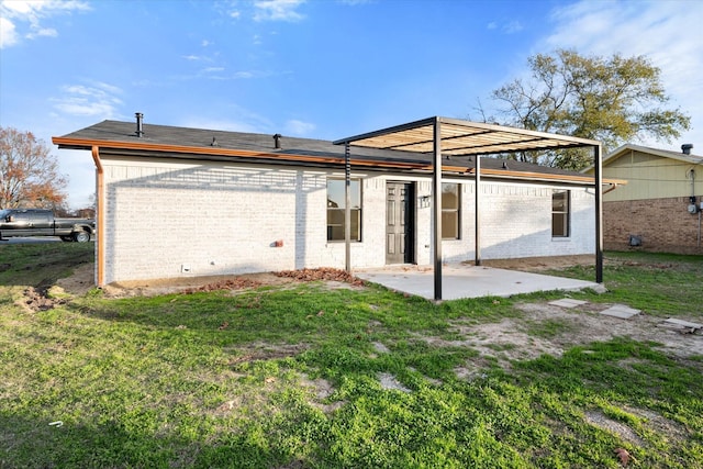 back of property featuring a patio and a lawn