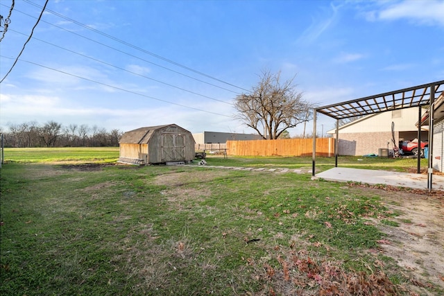 view of yard featuring a storage unit, a pergola, and a patio area