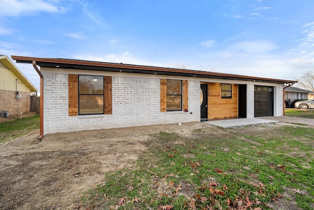 rear view of house with a garage