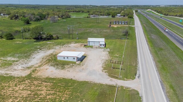 birds eye view of property with a rural view