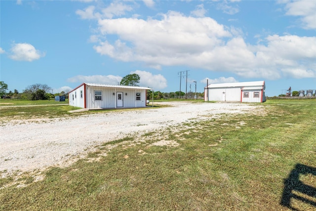 exterior space with an outbuilding and a front yard