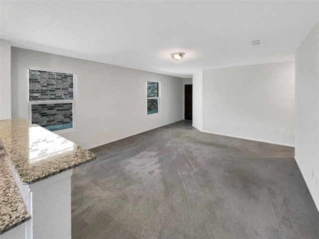 empty room featuring dark colored carpet