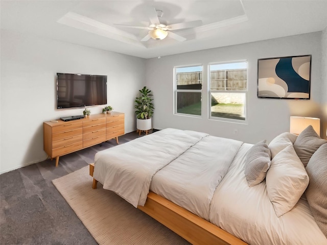 bedroom featuring a tray ceiling and ceiling fan