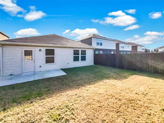 back of property featuring a yard and a patio