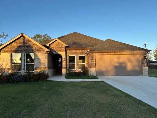 view of front of home with a garage and a front lawn