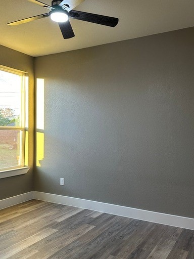 spare room featuring hardwood / wood-style flooring and ceiling fan