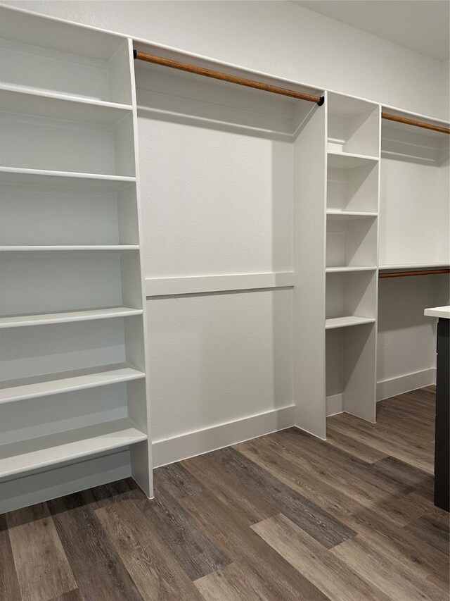 spacious closet with dark hardwood / wood-style floors