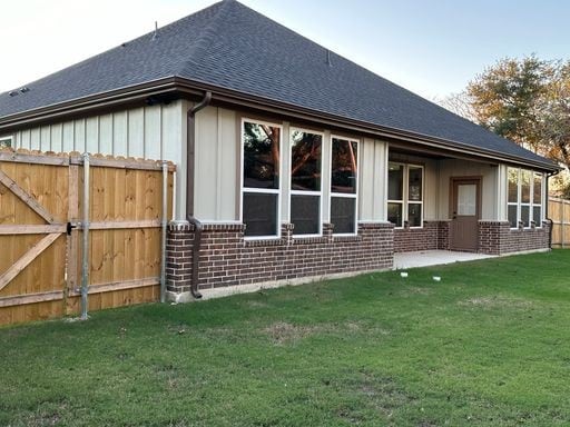 view of side of home featuring a yard