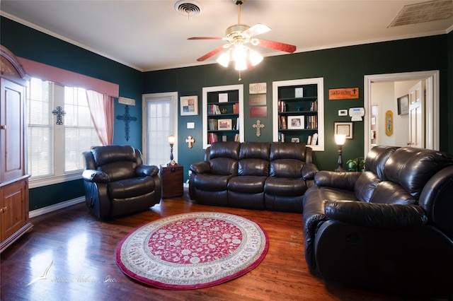 living room featuring crown molding, ceiling fan, built in features, and dark wood-type flooring