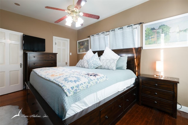 bedroom with dark hardwood / wood-style floors and ceiling fan