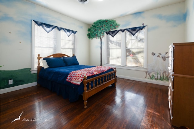 bedroom with dark hardwood / wood-style flooring and multiple windows